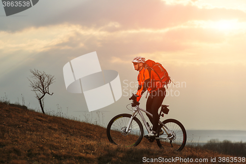 Image of Man cyclist with backpack riding the bicycle