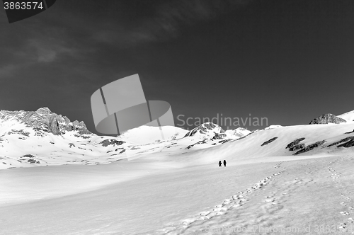 Image of Two hikers on snow plateau (black and white)