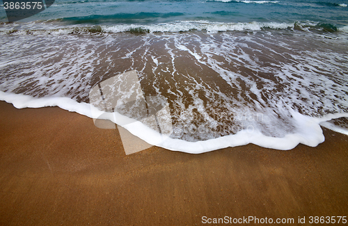 Image of Sea beach with waves in dull day