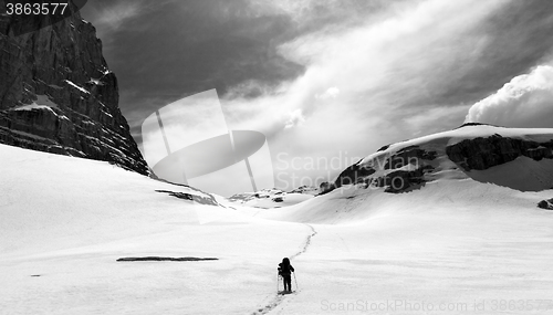 Image of Hiker on snow plateau. Black and white panoramic view.