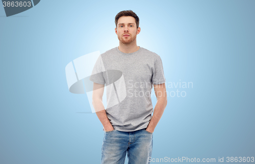 Image of young man in gray t-shirt and jeans