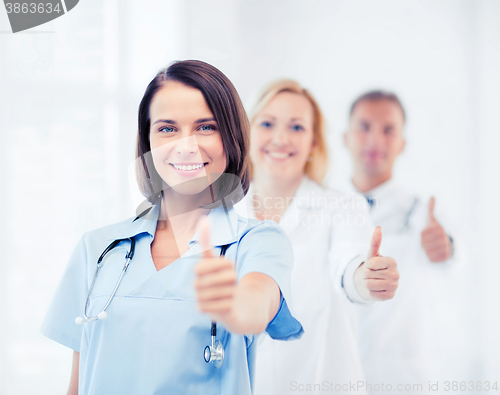 Image of team of doctors showing thumbs up