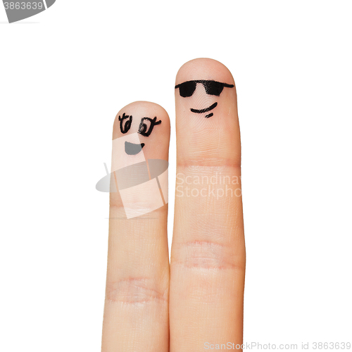 Image of close up of two fingers with smiley faces