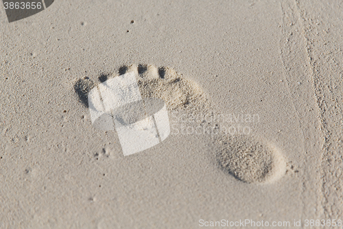 Image of human footprint on beach sand