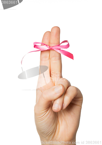 Image of close up of two fingers tied by pink bow knot