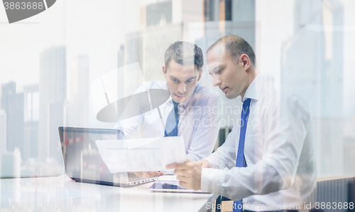 Image of two businessmen having discussion in office