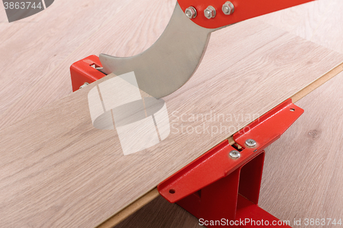 Image of Red tool for cutting laminate