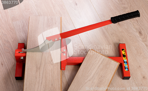 Image of Red tool for cutting laminate