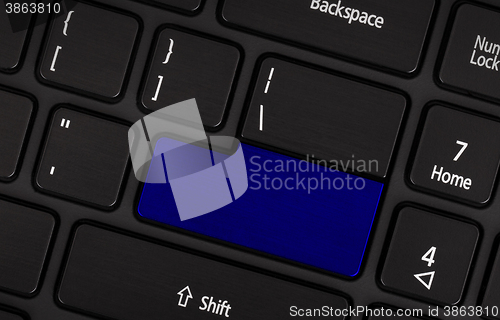 Image of Laptop computer keyboard with blank blue button