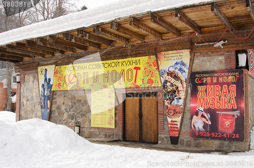 Image of Dombay, Russia - February 7, 2015: The restaurant Soviet cuisine \"Hammer and Sickle\" is located in the small town of Dombay