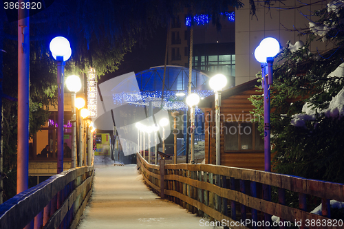 Image of Dombay, Russia - February 7, 2015: Night view of winter hanging cable-stayed bridge over the river Amanauz