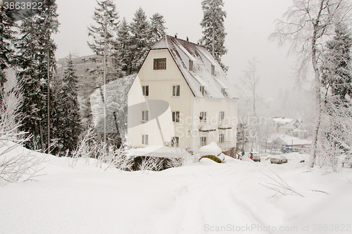 Image of Dombay, Russia - February 7, 2015: The yard facade of the snow-covered hotel \"Altair\", located in the small town of Dombay