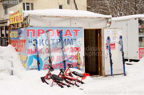 Image of Dombay, Russia - 7 February 2015: rental item \"Extreme\" skis, snowboards and other equipment located in the small town of Dombay