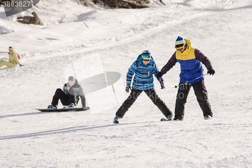 Image of Dombay, Russia - February 7, 2015: The instructor teaches how to ski on snow downhill ski training on the resort Dombay