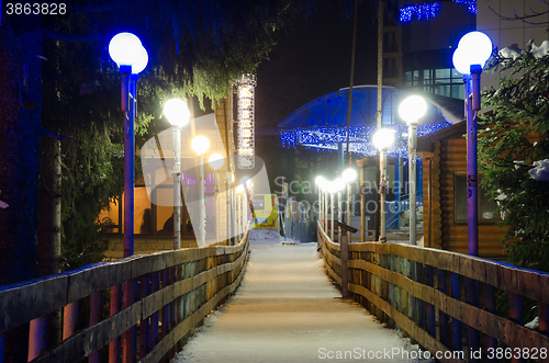 Image of Dombay, Russia - February 7, 2015: Night view of winter hanging cable-stayed bridge over the river Amanauz