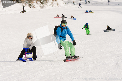 Image of Dombay, Russia - February 7, 2015: People ride on the snow-covered slopes of the ski resort Dombai