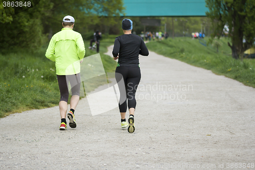 Image of Young man and woman running 