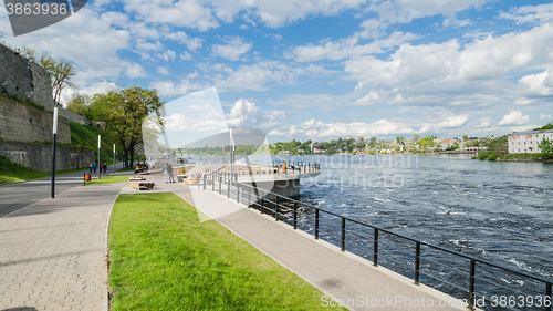 Image of Narva River embankment with vacationers people and the border of Russia and the European Union