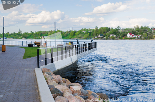 Image of Narva River embankment with vacationers people and the border of Russia and the European Union