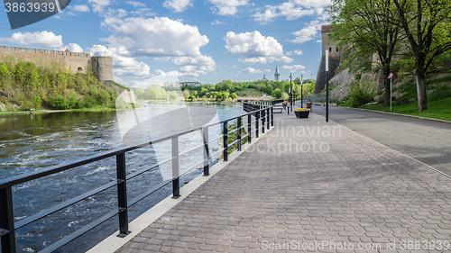 Image of Narva River embankment with vacationers people and the border of Russia and the European Union