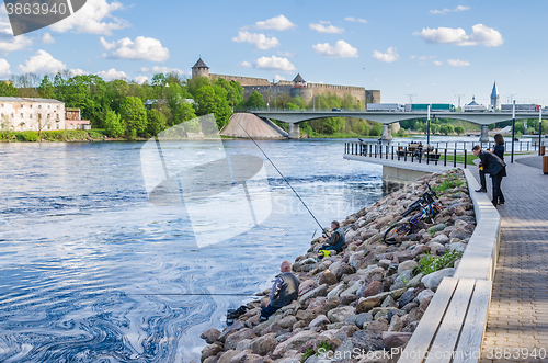 Image of Narva River embankment with vacationers people and the border of Russia and the European Union