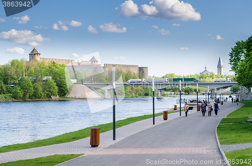 Image of Narva River embankment with vacationers people and the border of Russia and the European Union