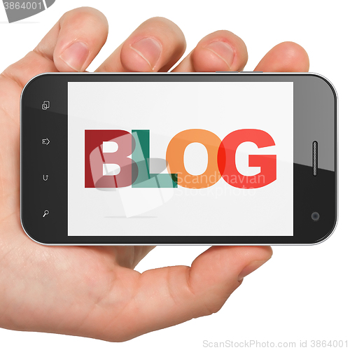 Image of Web design concept: Hand Holding Smartphone with Blog on  display