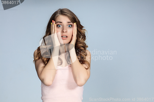 Image of Portrait of young woman with shocked facial expression