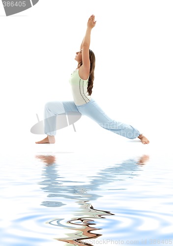 Image of virabhadrasana warrior pose on white sand #2