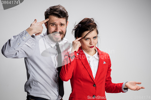 Image of The sad business man and woman conflicting on a gray background