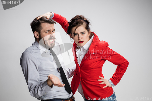 Image of The sad business man and woman conflicting on a gray background