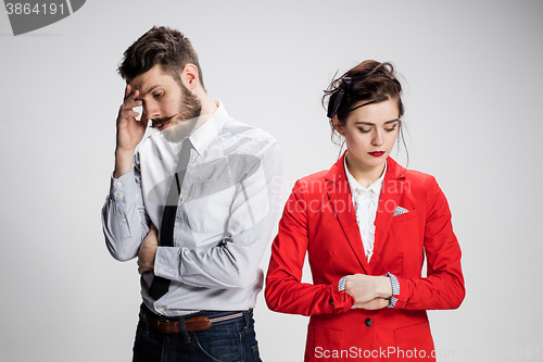 Image of The sad business man and woman conflicting on a gray background