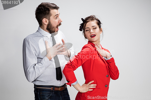 Image of The business man and woman communicating on a gray background