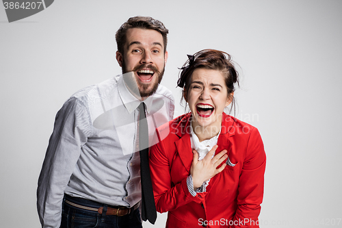 Image of The business man and woman laughing on a gray background