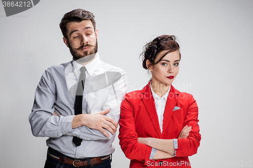 Image of The sad business man and woman conflicting on a gray background