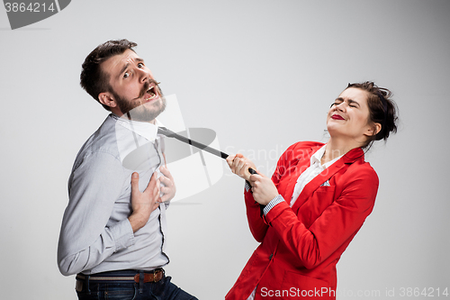 Image of The sad business man and woman conflicting on a gray background
