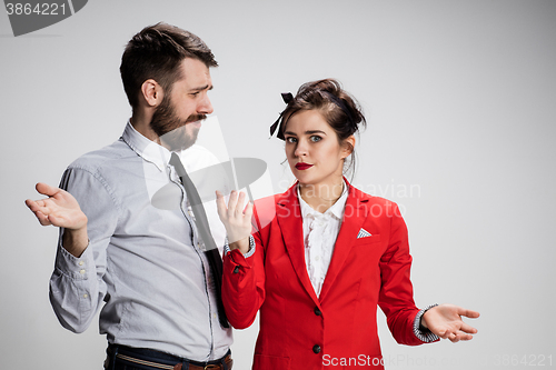 Image of The business man and woman communicating on a gray background