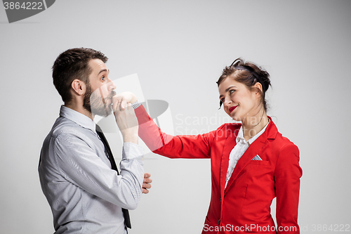 Image of The business man and woman communicating on a gray background