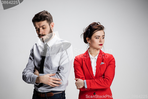 Image of The sad business man and woman conflicting on a gray background