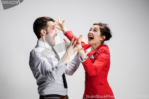 Image of The business man and woman laughing on a gray background