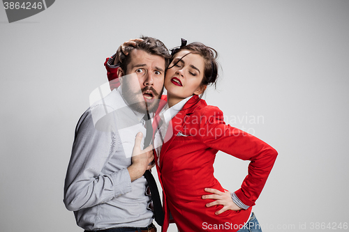 Image of The business man and woman communicating on a gray background
