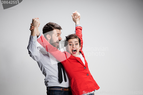 Image of The business man and woman laughing on a gray background