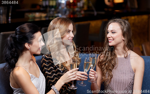 Image of happy women with champagne glasses at night club