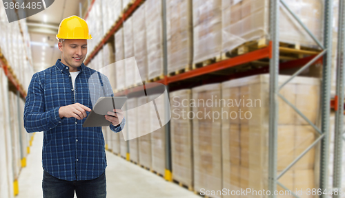 Image of happy businessman with tablet pc at warehouse