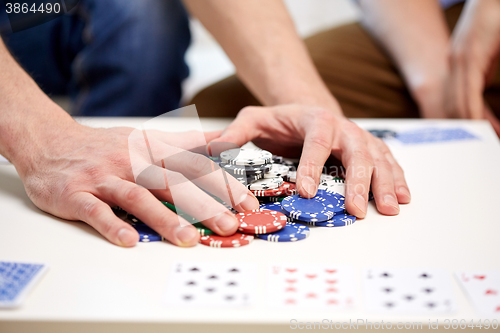 Image of hands with casino chips making bet or taking win