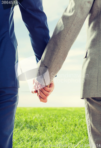 Image of close up of male gay couple holding hands