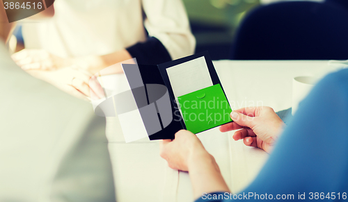 Image of close up of woman hands holding restaurant bill