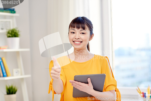 Image of happy asian woman student with tablet pc at home