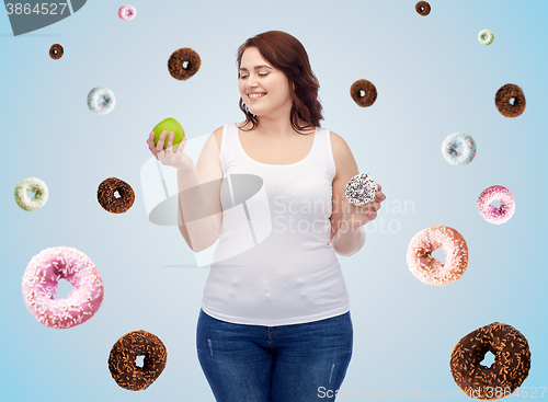 Image of happy plus size woman choosing apple or cookie