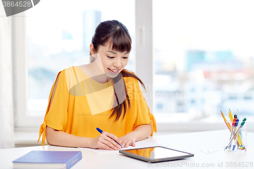 Image of happy asian woman student with tablet pc at home